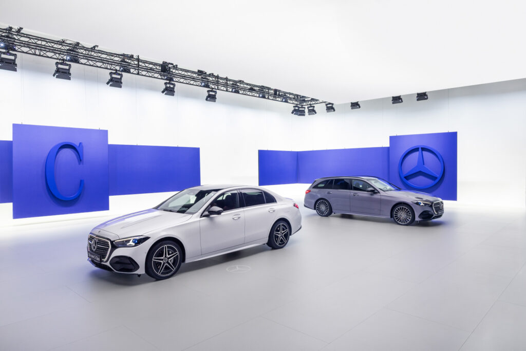 Mercedes Benz C Class Sedan and Estate Plug In Hybrid, model year 2026, shown in Opalite White Metallic and Lavender Silver.