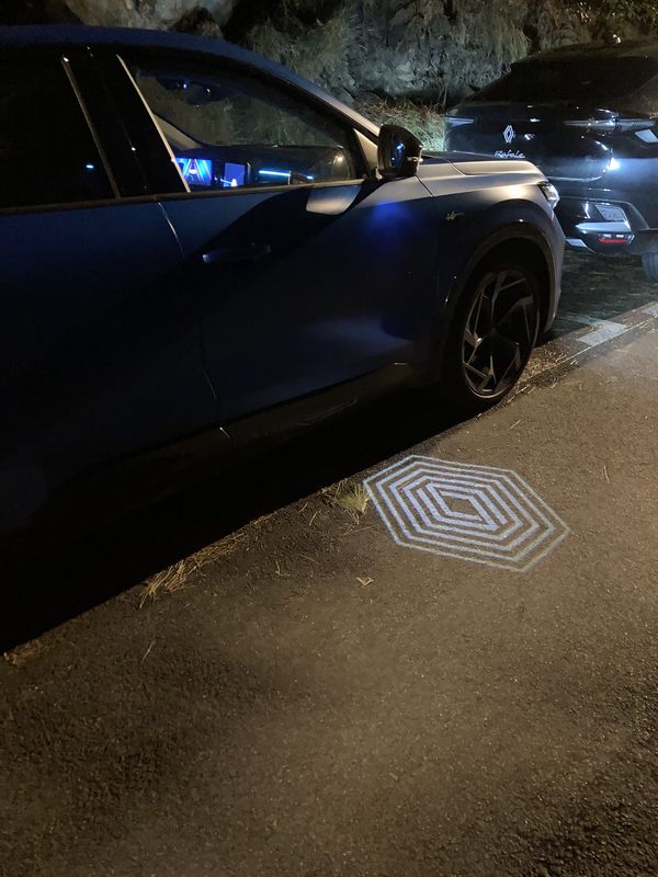 Renault Rafale E Tech 4×4 300 atelier Alpine, logo projection in the night.